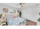 Bright bedroom with wood floors, a ceiling fan, and double door closet at 7727 9Th Avenue Nw Dr, Bradenton, FL 34209