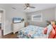 Bright bedroom with wood floors, a ceiling fan, and a large window at 7727 9Th Avenue Nw Dr, Bradenton, FL 34209