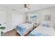 Bedroom featuring two twin beds, wood floors, and natural light at 7727 9Th Avenue Nw Dr, Bradenton, FL 34209