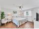 Serene bedroom with wood floors, a ceiling fan, and a bright window at 7727 9Th Avenue Nw Dr, Bradenton, FL 34209