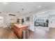 Open-concept kitchen with a center island, granite countertops, and stainless steel appliances overlooking the Gathering room at 7727 9Th Avenue Nw Dr, Bradenton, FL 34209
