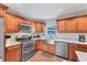 Modern kitchen with stainless steel appliances, granite countertops, and wood flooring at 7727 9Th Avenue Nw Dr, Bradenton, FL 34209