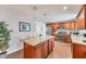 Well-equipped kitchen featuring wood cabinets, stainless steel appliances, granite countertops, and a convenient center island at 7727 9Th Avenue Nw Dr, Bradenton, FL 34209
