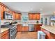 Kitchen featuring stainless steel appliances, stone countertops and hardwood floors at 7727 9Th Avenue Nw Dr, Bradenton, FL 34209