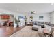 Comfortable living room featuring a large sectional sofa, hardwood floors, and open access to the kitchen at 7727 9Th Avenue Nw Dr, Bradenton, FL 34209