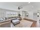 Bright living room with a comfortable sectional sofa, wood floors, and contemporary decor at 7727 9Th Avenue Nw Dr, Bradenton, FL 34209