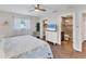 Relaxing main bedroom featuring a ceiling fan, wood floors, and an ensuite bathroom at 7727 9Th Avenue Nw Dr, Bradenton, FL 34209