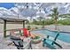 Beautiful pool area with pavers, fire pit, string lights, and ample seating for entertaining at 7727 9Th Avenue Nw Dr, Bradenton, FL 34209
