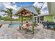 Poolside pavilion with seating, perfect for outdoor dining and entertaining near the sparkling pool at 7727 9Th Avenue Nw Dr, Bradenton, FL 34209