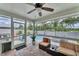 Inviting screened patio with comfortable seating, ceiling fan, and a view of the pool and backyard at 7727 9Th Avenue Nw Dr, Bradenton, FL 34209