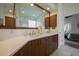This bright bathroom features a double sink vanity and a modern glass shower at 7952 Hampton Ct, University Park, FL 34201