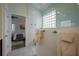 Bright bathroom features a glass shower with marble wall, a glass block window, and a towel rack at 7952 Hampton Ct, University Park, FL 34201