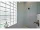 Beautiful bathroom features a glass shower with modern fixtures and a glass block window at 7952 Hampton Ct, University Park, FL 34201