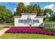 University Park Country Club entrance sign surrounded by lush greenery and colorful flowers under a blue sky at 7952 Hampton Ct, University Park, FL 34201