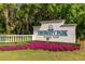 A warm welcome at the University Park Country Club entrance with vibrant flowers and an elegant sign at 7952 Hampton Ct, University Park, FL 34201