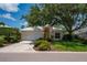 Attractive single-story home featuring an attached garage and beautiful mature landscaping at 7952 Hampton Ct, University Park, FL 34201