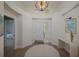 Bright foyer with high ceilings, decorative lighting, and a view into the adjacent rooms at 7952 Hampton Ct, University Park, FL 34201