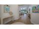 Inviting entry with light wood floors, elegant decor, and a glimpse into the spacious living areas at 7952 Hampton Ct, University Park, FL 34201