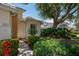 Beautifully landscaped front yard showcasing lush greenery and vibrant flowerbeds, leading to the home's entrance at 7952 Hampton Ct, University Park, FL 34201