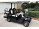 Stylish black golf cart with seating for four, ready for leisure and convenient neighborhood travels at 7952 Hampton Ct, University Park, FL 34201