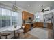 A modern kitchen featuring wood cabinets, stainless steel appliances, and a breakfast nook at 7952 Hampton Ct, University Park, FL 34201