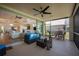 Inviting lanai with an open view of interior, comfortable seating, ceiling fan, and outdoor grill at 7952 Hampton Ct, University Park, FL 34201