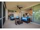 Spacious lanai with comfortable seating, ceiling fan, and views into the home and tropical landscape at 7952 Hampton Ct, University Park, FL 34201