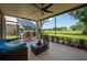 Charming lanai features comfortable seating and serene golf course views through the screened enclosure at 7952 Hampton Ct, University Park, FL 34201