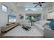 A stylish living room featuring vaulted ceilings, modern decor, and a large screen TV at 7952 Hampton Ct, University Park, FL 34201