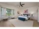 Bright main bedroom features a ceiling fan, seating area, and views from the large bay window at 7952 Hampton Ct, University Park, FL 34201