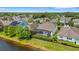 Aerial view showcases the home's screened pool and proximity to a serene lake at 843 Molly Cir, Sarasota, FL 34232