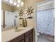 Nautical themed bathroom with a decorative mirror, single sink vanity, and shower-tub combination at 843 Molly Cir, Sarasota, FL 34232