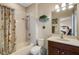 Bathroom with a shower-tub combination, neutral vanity, and decorative mirror with views of the bedroom at 843 Molly Cir, Sarasota, FL 34232
