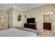 Bedroom featuring a media center, neutral carpet, and a door leading to the bathroom at 843 Molly Cir, Sarasota, FL 34232
