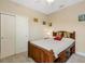 Bedroom with hardwood bed and a comfortable neutral carpet, with a closet for storage at 843 Molly Cir, Sarasota, FL 34232