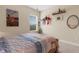 Comfortable bedroom with natural light, featuring a queen bed and neutral carpet and wall colors at 843 Molly Cir, Sarasota, FL 34232