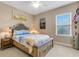 Cozy bedroom with neutral walls, a queen bed, and plenty of natural light from the window at 843 Molly Cir, Sarasota, FL 34232