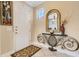 Bright entryway featuring a decorative mirror, console table, tile flooring, and a white front door at 843 Molly Cir, Sarasota, FL 34232