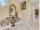 Elegant hallway with tile flooring, decorative mirror, console table, and access to various rooms at 843 Molly Cir, Sarasota, FL 34232