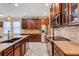 Stylish kitchen featuring granite countertops, stainless steel appliances, wooden cabinets, and tile backsplash at 843 Molly Cir, Sarasota, FL 34232