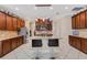 Well-equipped kitchen with granite counters, wooden cabinets, stainless steel appliances, and an island with seating at 843 Molly Cir, Sarasota, FL 34232