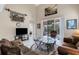 Spacious living room featuring high ceilings, large windows, comfortable seating, and access to outdoor patio at 843 Molly Cir, Sarasota, FL 34232