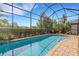 Beautiful, screened pool with brick accents and lush landscaping at 843 Molly Cir, Sarasota, FL 34232