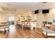 Elegant bar area with wooden floors, bar seating, and a fully stocked bar, perfect for entertaining at 8579 54Th Avenue E Cir, Bradenton, FL 34211
