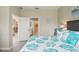 Bedroom with a queen size bed, coastal style decor, and doorway that reveals a glimpse into the kitchen at 8579 54Th Avenue E Cir, Bradenton, FL 34211
