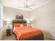 A cozy bedroom featuring a queen-size bed, bedside tables, and a ceiling fan for added comfort at 8579 54Th Avenue E Cir, Bradenton, FL 34211