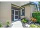 Inviting screened-in entryway with lush landscaping and an elegant aesthetic at 8579 54Th Avenue E Cir, Bradenton, FL 34211