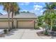 Charming home with a two-car garage, beautiful landscaping, and a manicured lawn at 8579 54Th Avenue E Cir, Bradenton, FL 34211