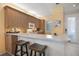 Well-lit kitchen featuring barstool seating, ample counter space, and modern appliances at 8579 54Th Avenue E Cir, Bradenton, FL 34211