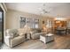 Bright living room showcasing wood floors, large windows, and stylish furniture at 8579 54Th Avenue E Cir, Bradenton, FL 34211